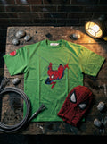 Green Streetwear T-shirt featuring a red character graphic and a circular branded sleeve patch.